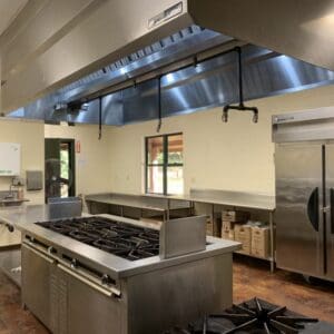 A kitchen with stainless steel appliances and a large counter.