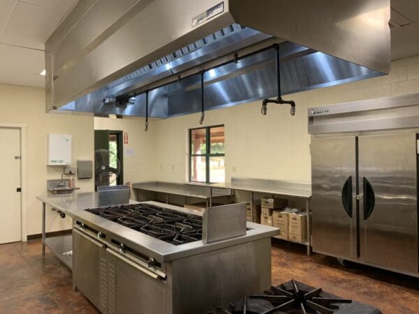 A kitchen with stainless steel appliances and a large counter.