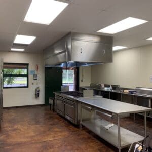 A kitchen with stainless steel counters and a large counter.