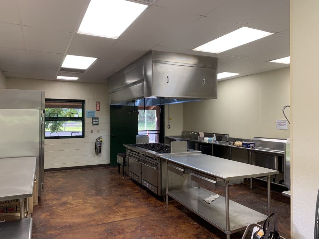 A kitchen with stainless steel counters and a large counter.